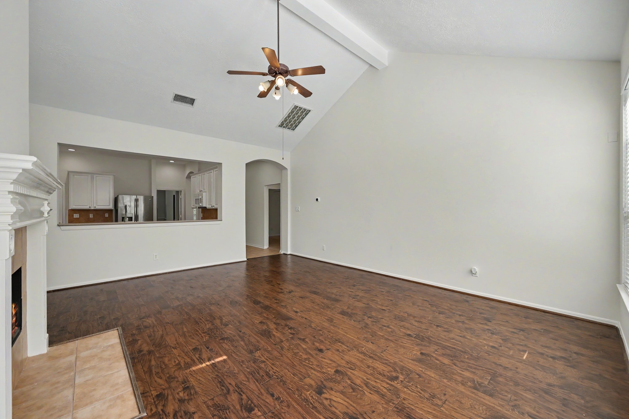 14 South Rambling Ridge Place The Woodlands, TX 77385 - Photo 12 of 42 Open-concept family room offers generous space for relaxing and entertaining with seamless sightlines into the kitchen and breakfast area.