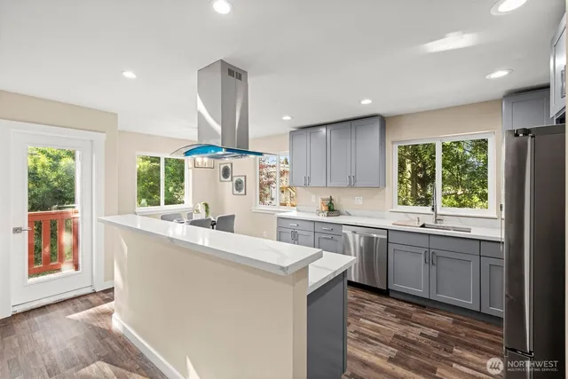 a kitchen with a sink stainless steel appliances and cabinets