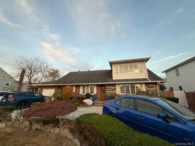 a front view of a house with garden space and deck
