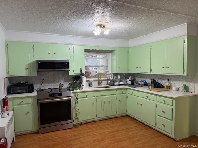 113 Parma Road Island Park, NY 11558 - Photo 2 of 12 a kitchen with a sink stove and cabinets