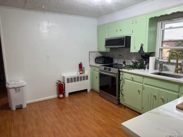 a kitchen with a sink cabinets and a wooden floor