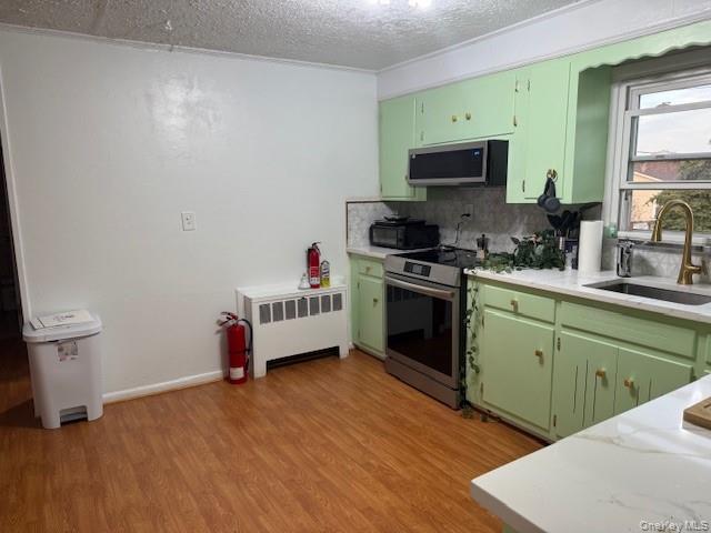 113 Parma Road Island Park, NY 11558 - Photo 3 of 12 a kitchen with a sink cabinets and a wooden floor