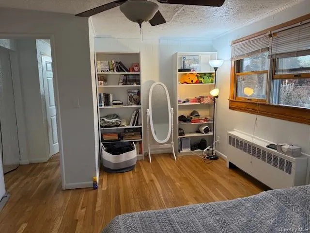 a bedroom with furniture and a wooden floor
