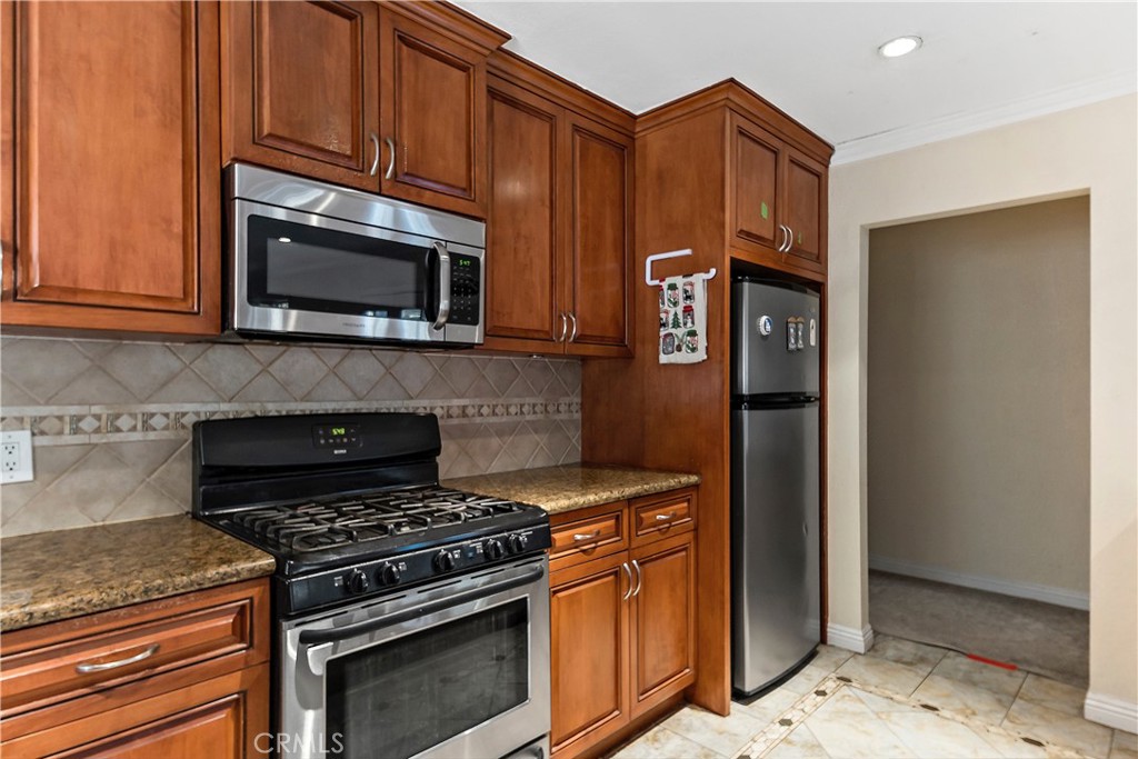 3524 Whitingham Drive West Covina, CA 91792 - Photo 11 of 39 a kitchen with stainless steel appliances granite countertop a stove top oven microwave and refrigerator
