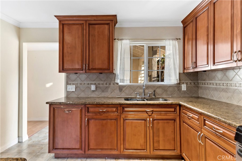 3524 Whitingham Drive West Covina, CA 91792 - Photo 12 of 39 a kitchen with granite countertop wooden cabinets and a sink