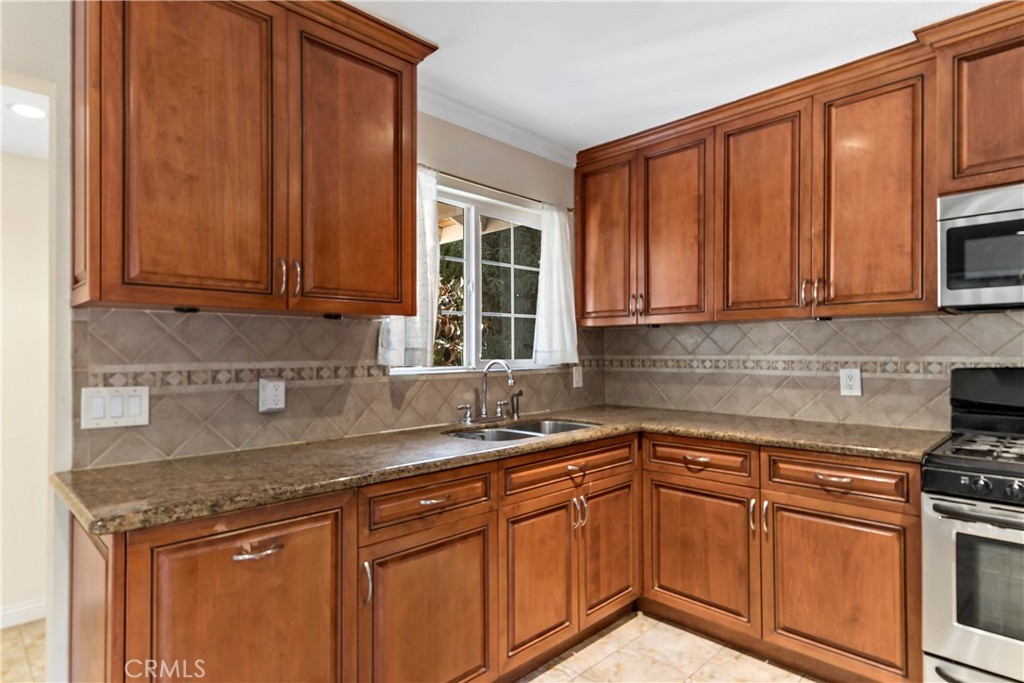 3524 Whitingham Drive West Covina, CA 91792 - Photo 13 of 39 a kitchen with stainless steel appliances granite countertop a sink stove and cabinets