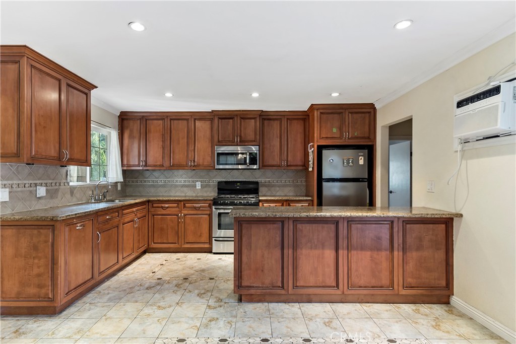 3524 Whitingham Drive West Covina, CA 91792 - Photo 8 of 39 a kitchen with stainless steel appliances granite countertop wooden cabinets a stove top oven a sink and dishwasher