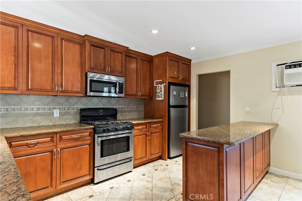 3524 Whitingham Drive West Covina, CA 91792 - Photo 9 of 39 a kitchen with stainless steel appliances granite countertop a stove a sink dishwasher a refrigerator and a microwave oven