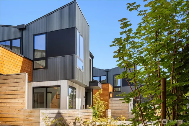a front view of a building with a tree