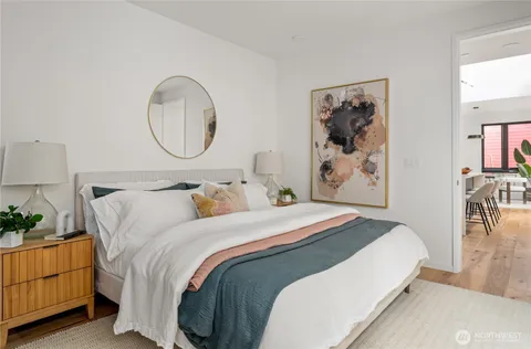 a bedroom with bed and wall painting