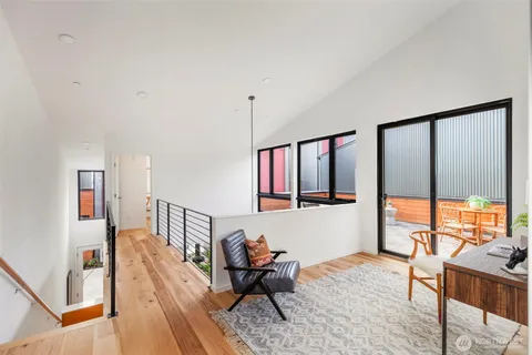 a living room with furniture and large windows