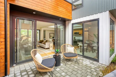a view of a patio with couple of chairs and a table