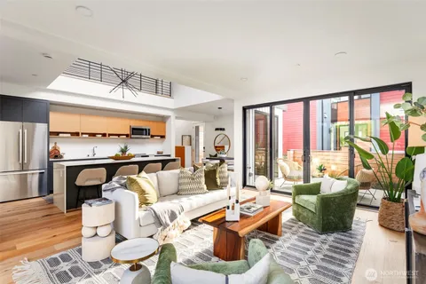 a living room with furniture fireplace and a large window