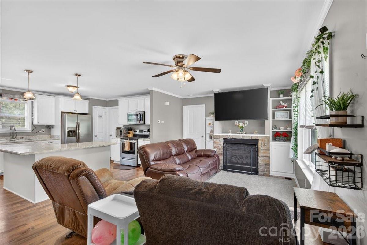 567 Godbey Road Mocksville, NC 27028 - Photo 4 of 38 a living room with furniture a fireplace and a flat screen tv