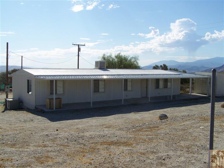 15303 Country View Road Whitewater, CA 92282 - Photo 12 of 25 a front view of a house with a yard and garage