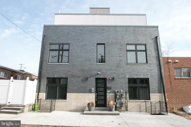 a front view of a house with large windows