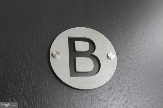 a kitchen with granite countertop a refrigerator stove and sink