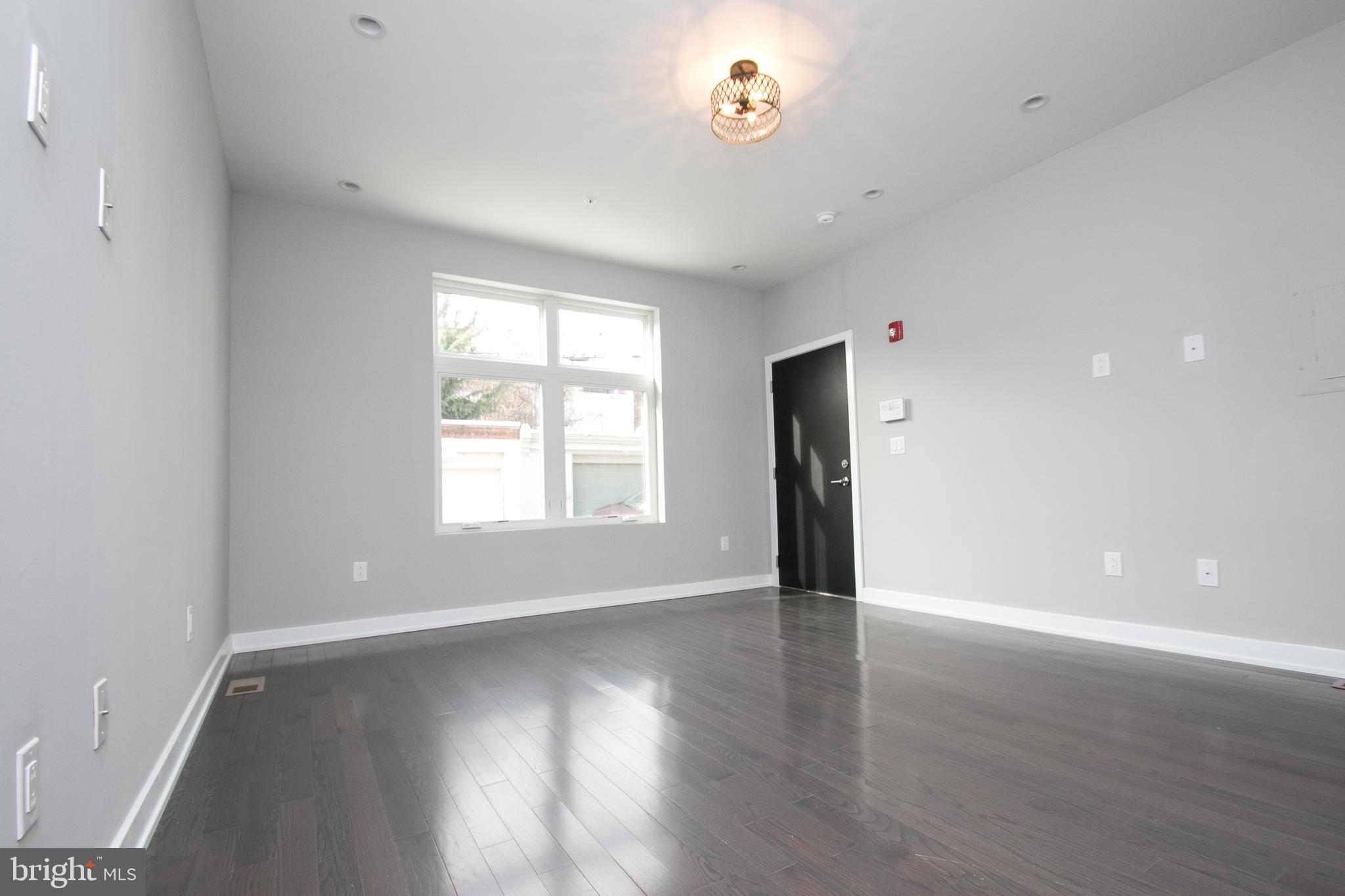 755 North Capitol Street Philadelphia, PA 19130 - Photo 13 of 47 an empty room with wooden floor and windows