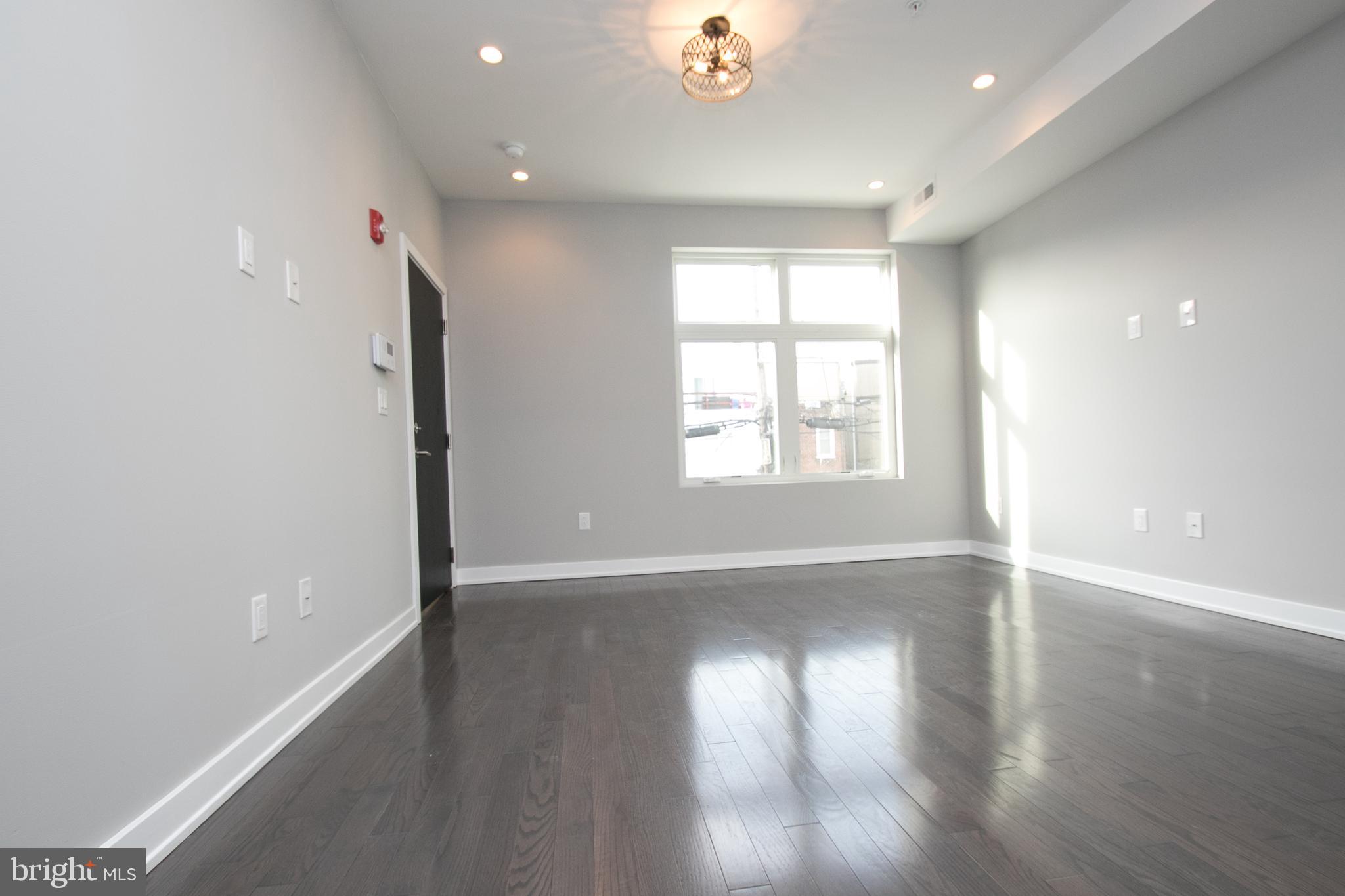 755 North Capitol Street Philadelphia, PA 19130 - Photo 21 of 47 an empty room with wooden floor and windows