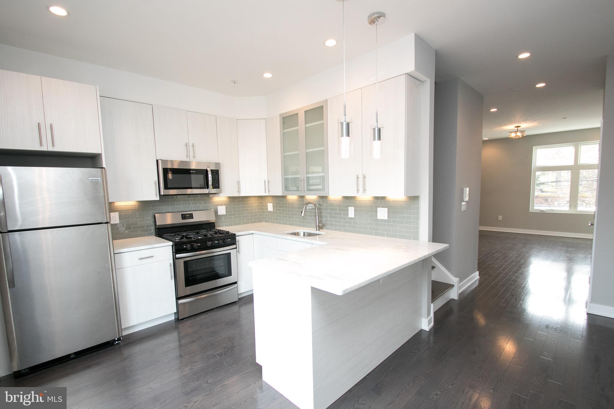 755 North Capitol Street Philadelphia, PA 19130 - Photo 23 of 47 a kitchen with a sink a stove a refrigerator and a refrigerator