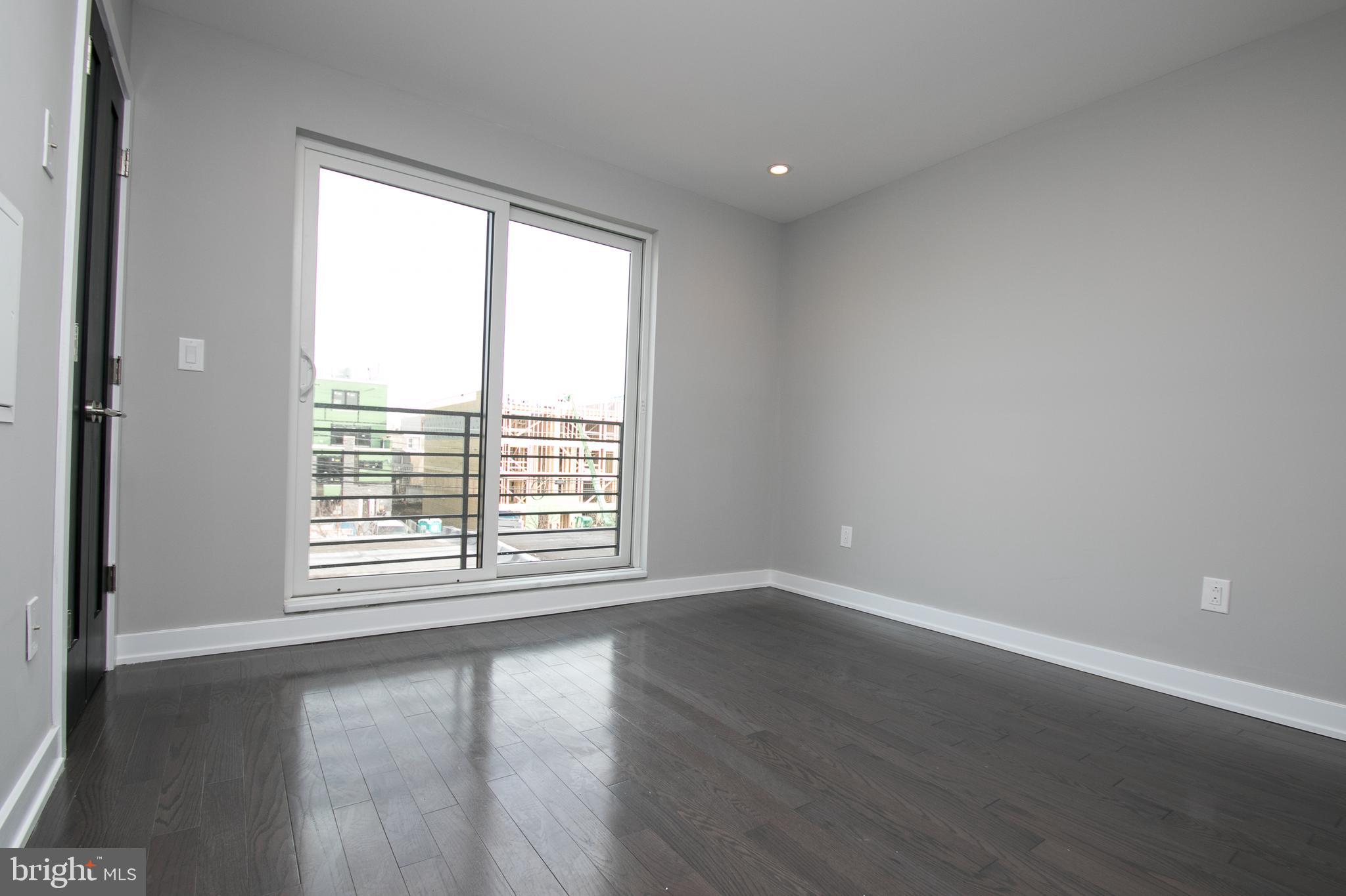 755 North Capitol Street Philadelphia, PA 19130 - Photo 28 of 47 a view of an empty room with wooden floor and a window