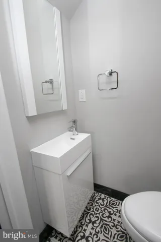 a bathroom with a sink a mirror and vanity