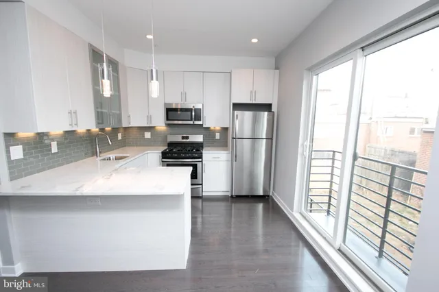 a view of a room with a sink and cabinets