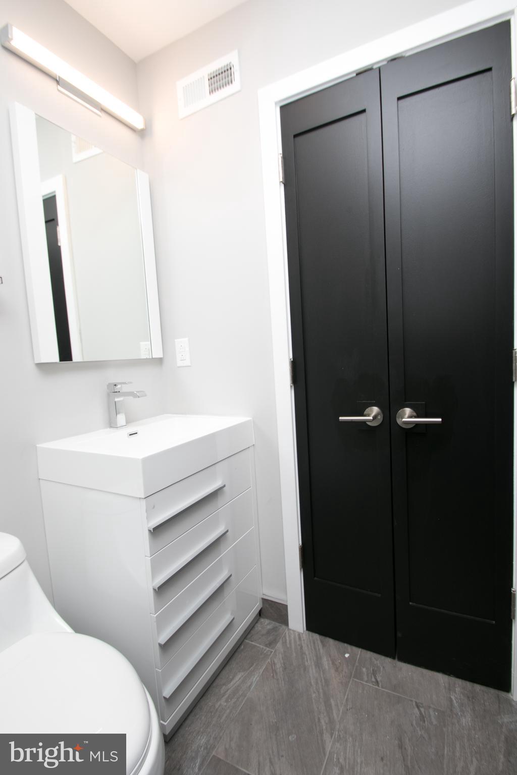 755 North Capitol Street Philadelphia, PA 19130 - Photo 41 of 47 a bathroom with a sink a mirror and vanity