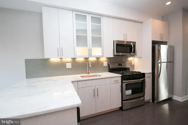 a view of a kitchen with a sink and cabinets