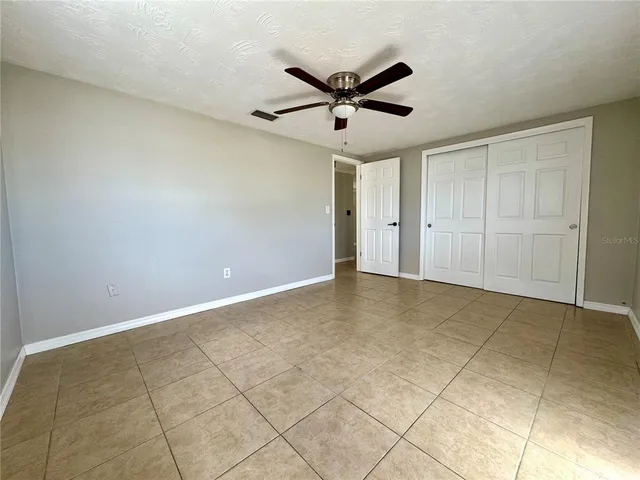 a view of a livingroom with a ceiling fan and window