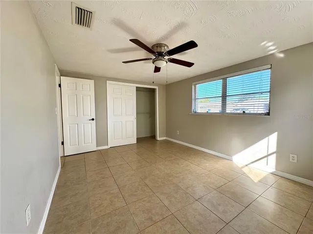 a view of a livingroom with a ceiling fan and window