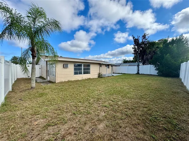 a yellow house with a yard