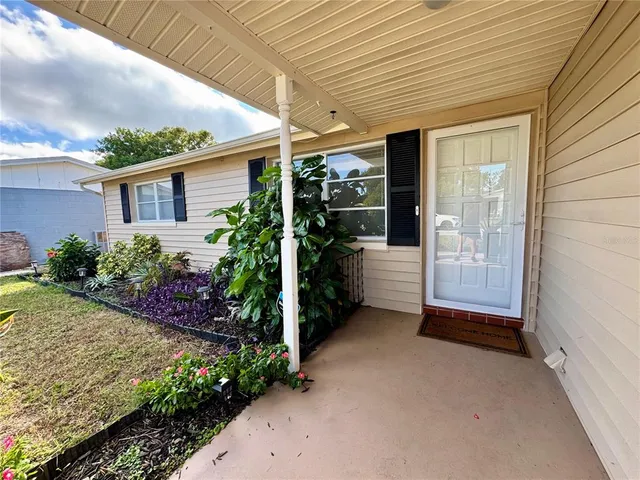 a view of a porch with plants and entryway