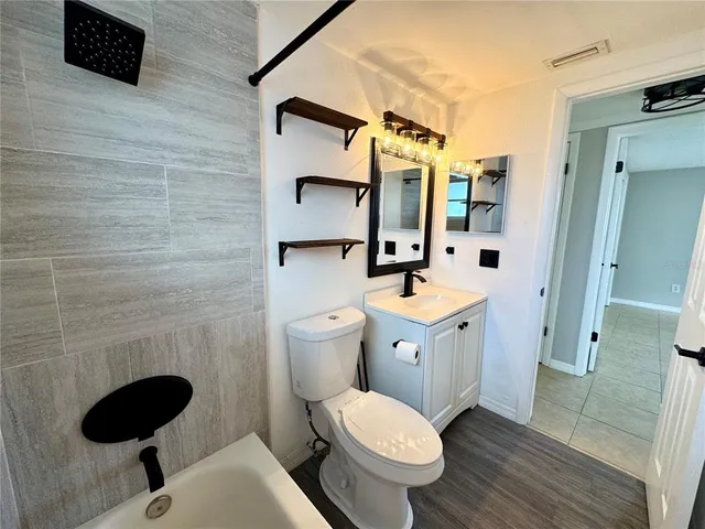 a bathroom with a toilet sink and shower