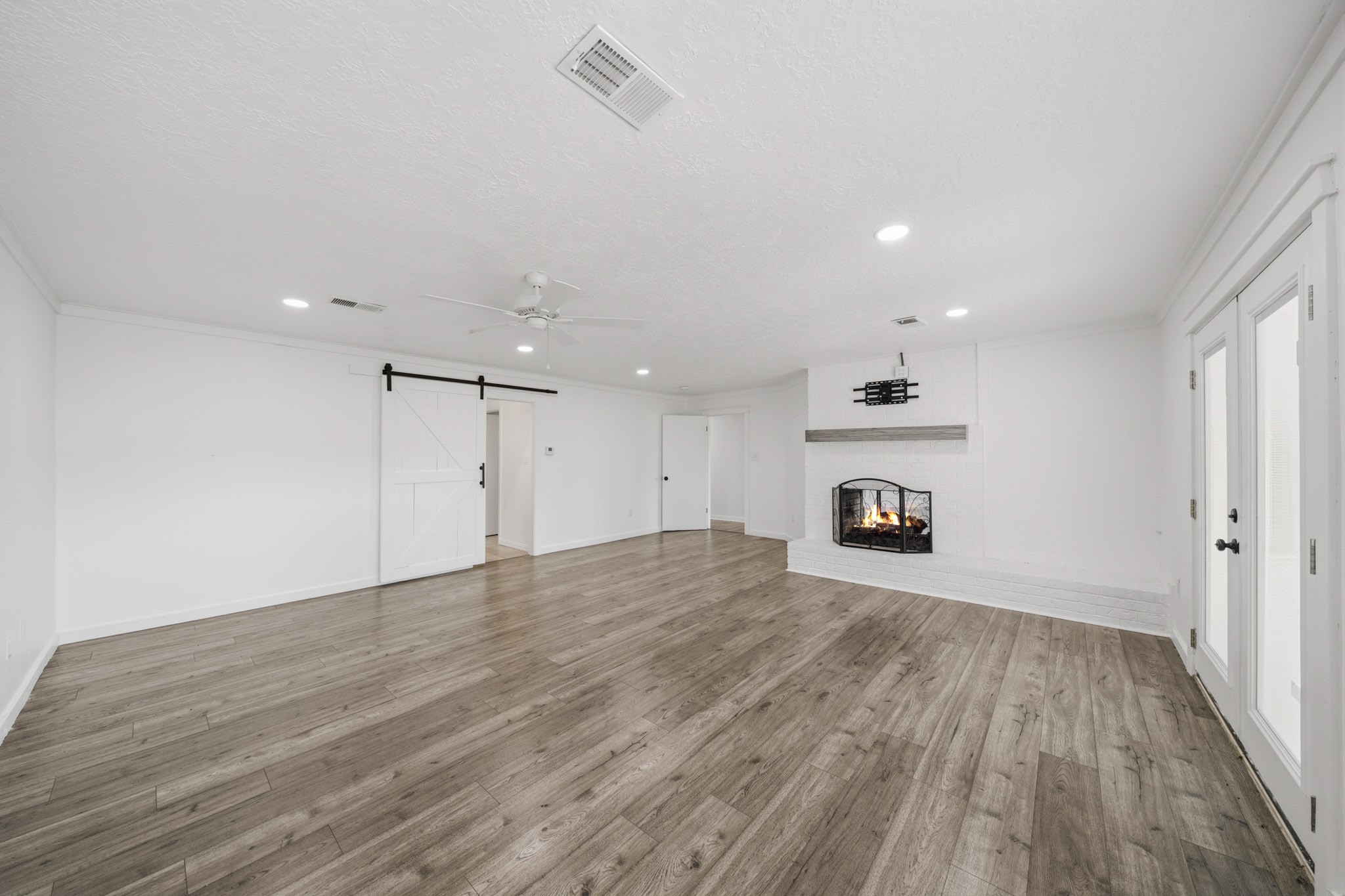 79 Summers Wind Street Conroe, TX 77356 - Photo 21 of 45 a view of an empty room with wooden floor and a window