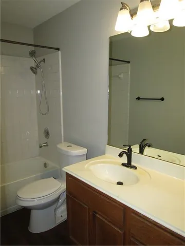 a bathroom with a sink mirror toilet and bathtub