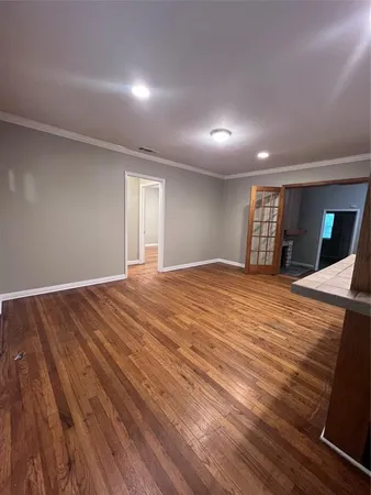 a big room with wooden floor and balcony