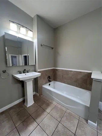 a bathroom with a sink a mirror and a bathtub