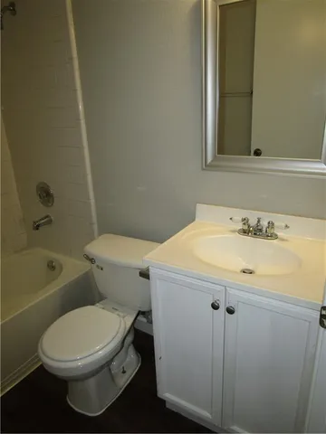 a bathroom with a sink a toilet and bathtub