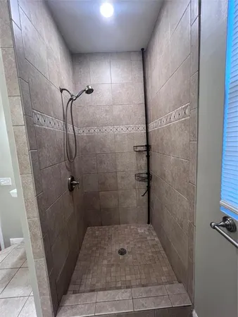 a bathroom with a glass door shower