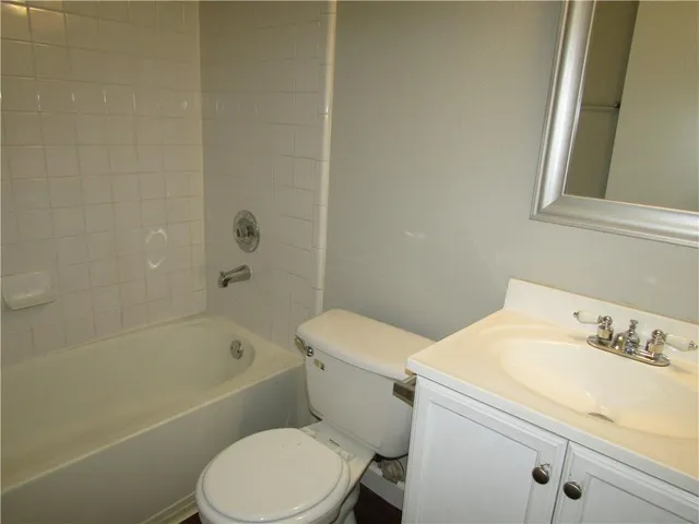 a bathroom with a sink a toilet and bathtub