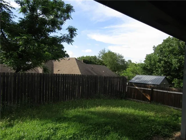 a backyard of a house with lots of green space