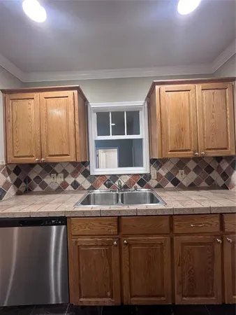 a kitchen with a sink stove and cabinets