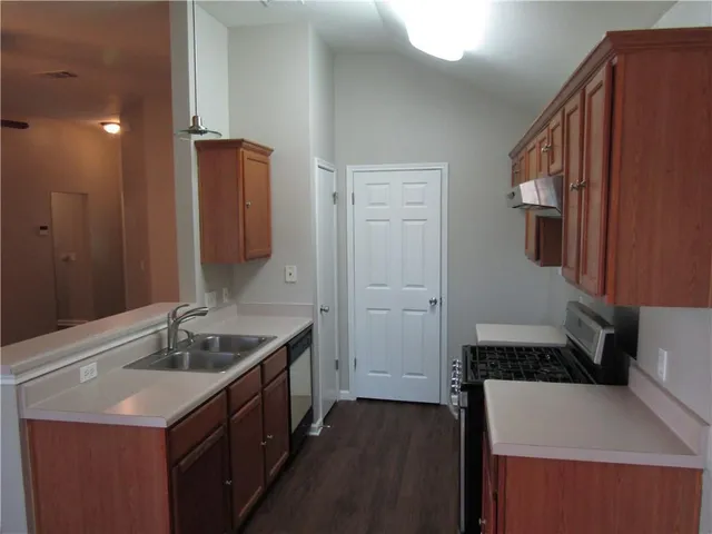 a kitchen with a sink and a refrigerator