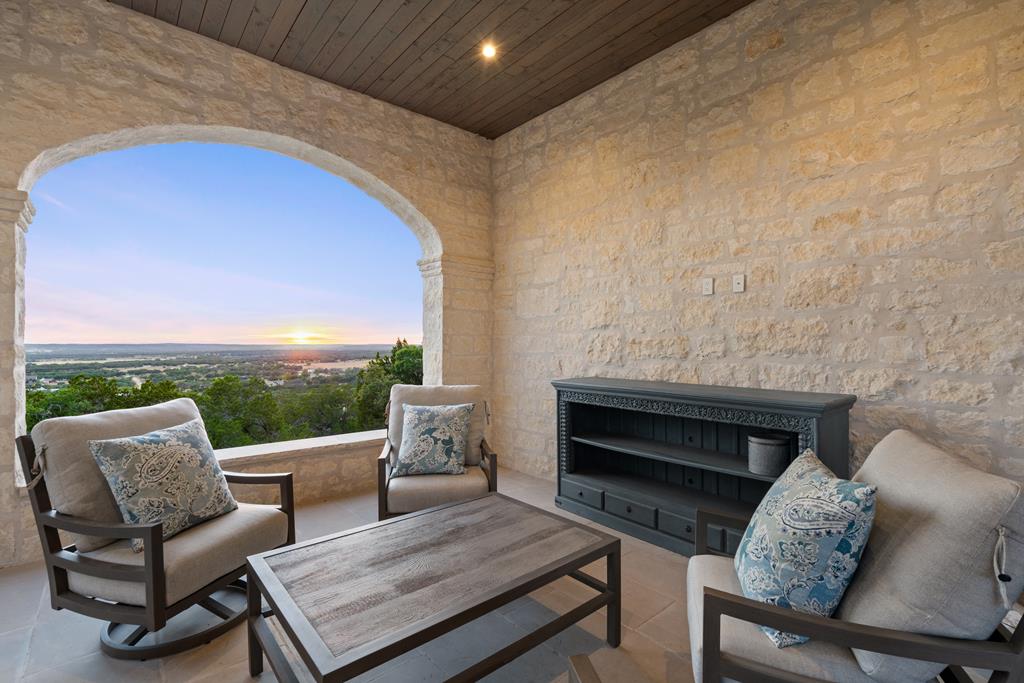 1691 Cool Water Ranch Road Fredericksburg, TX 78624 - Photo 11 of 33 a living room with furniture and a fireplace