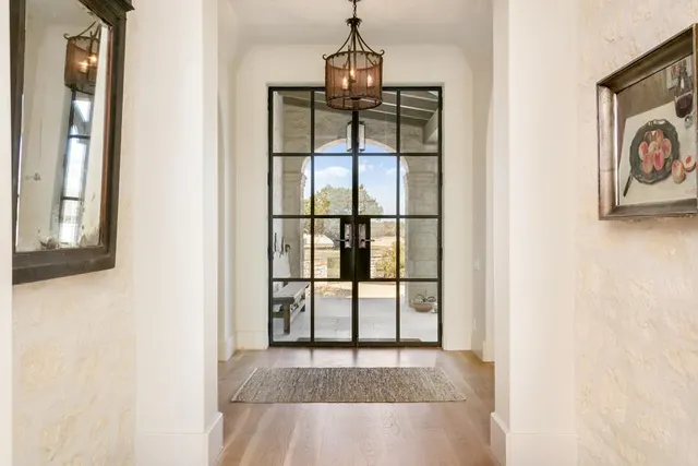 a view of a dining room with furniture a chandelier and wooden floor