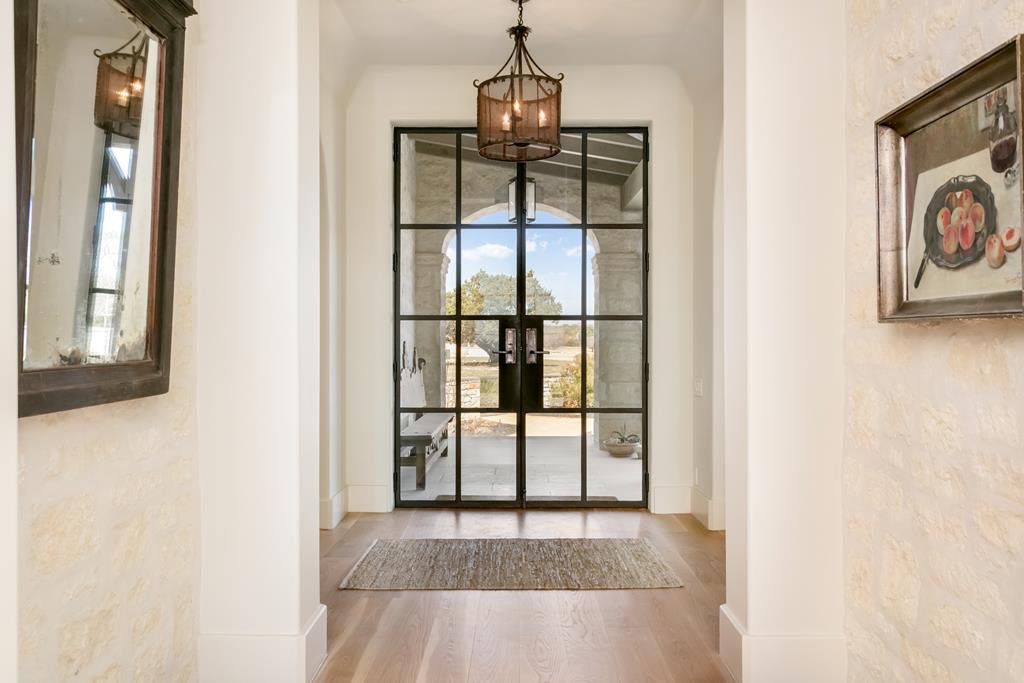 1691 Cool Water Ranch Road Fredericksburg, TX 78624 - Photo 12 of 33 a view of a hallway with wooden floor and dining room