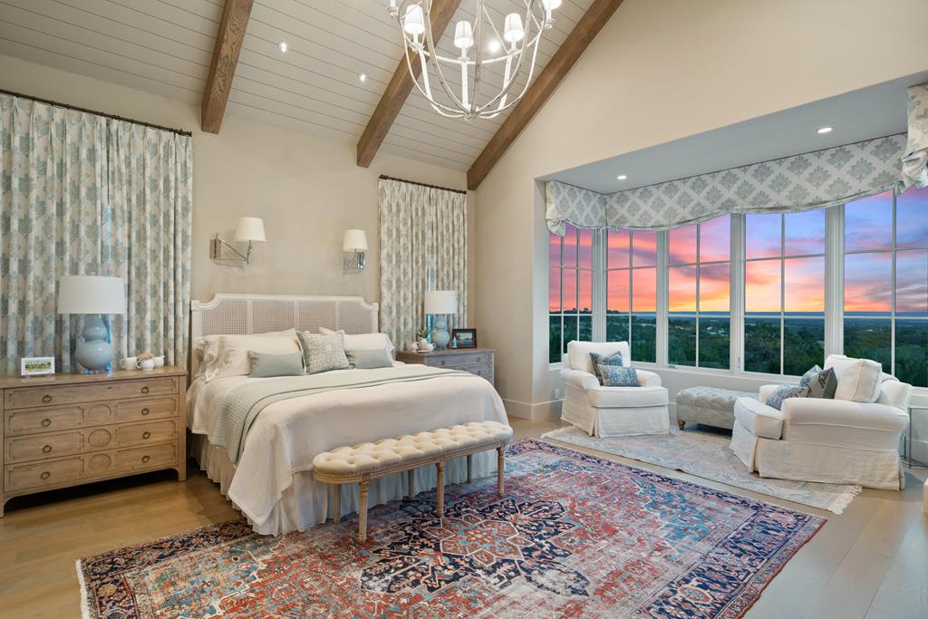 1691 Cool Water Ranch Road Fredericksburg, TX 78624 - Photo 20 of 33 a bedroom with a large bed and a couch