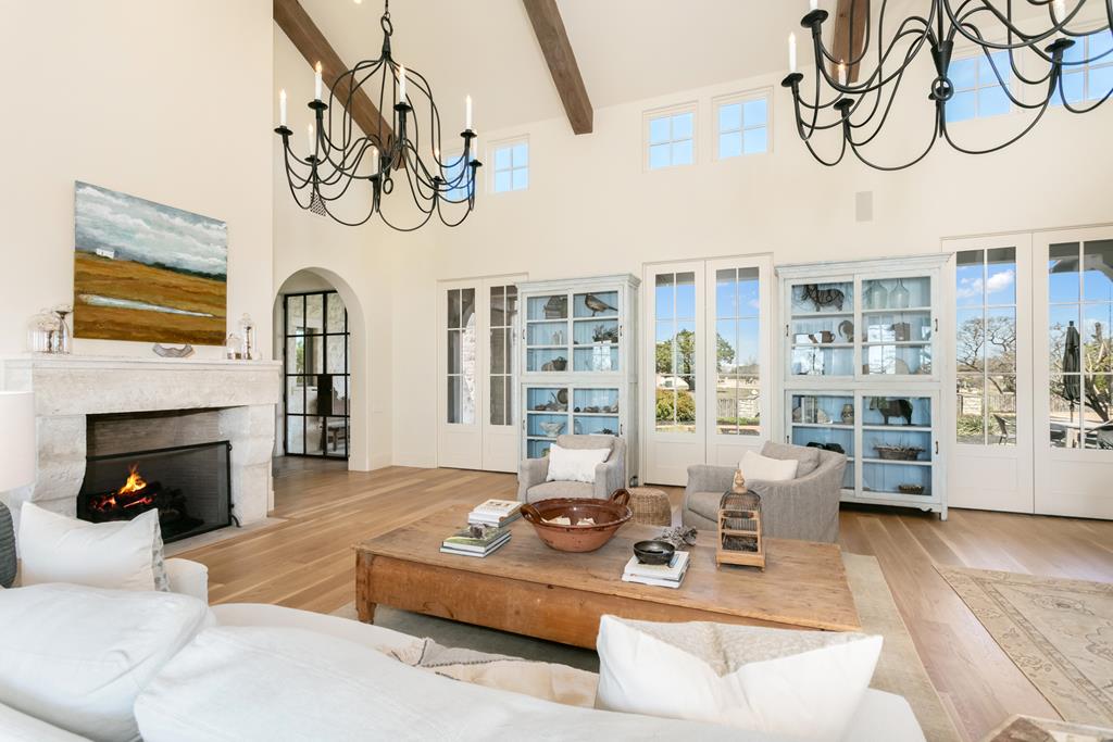 1691 Cool Water Ranch Road Fredericksburg, TX 78624 - Photo 23 of 33 a living room with furniture a fireplace and wooden floor