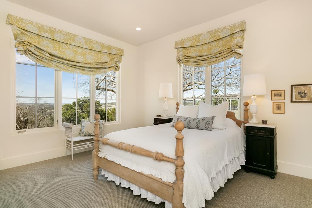 1691 Cool Water Ranch Road Fredericksburg, TX 78624 - Photo 25 of 33 a bedroom with a bed and a window